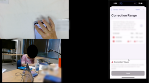 Screenshot of a recording from a study session. In the top left corner there is an overhead view of someone's hand on a phone, in the bottom left there is a view of the room with the participant, and on the right side there is a large view of the phone screen which is directly mirrored.